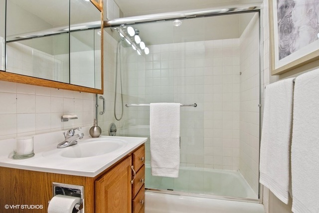 655 West Irving Park Road, Unit 2311 Chicago, IL 60613 - Photo 11 of 21 a bathroom with a sink and a mirror