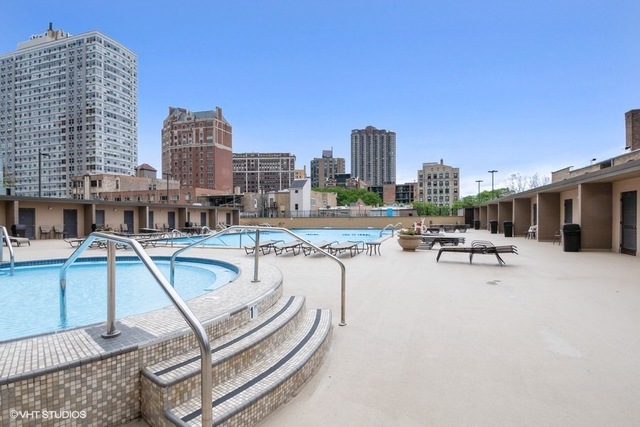 655 West Irving Park Road, Unit 2311 Chicago, IL 60613 - Photo 12 of 21 a swimming pool with outdoor seating and city view