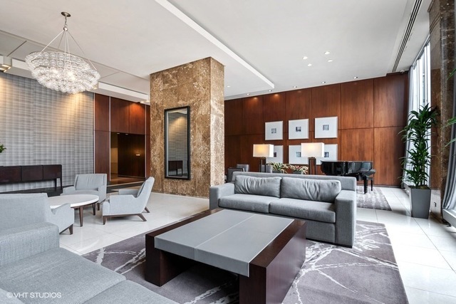 655 West Irving Park Road, Unit 2311 Chicago, IL 60613 - Photo 16 of 21 a living room with furniture and a chandelier