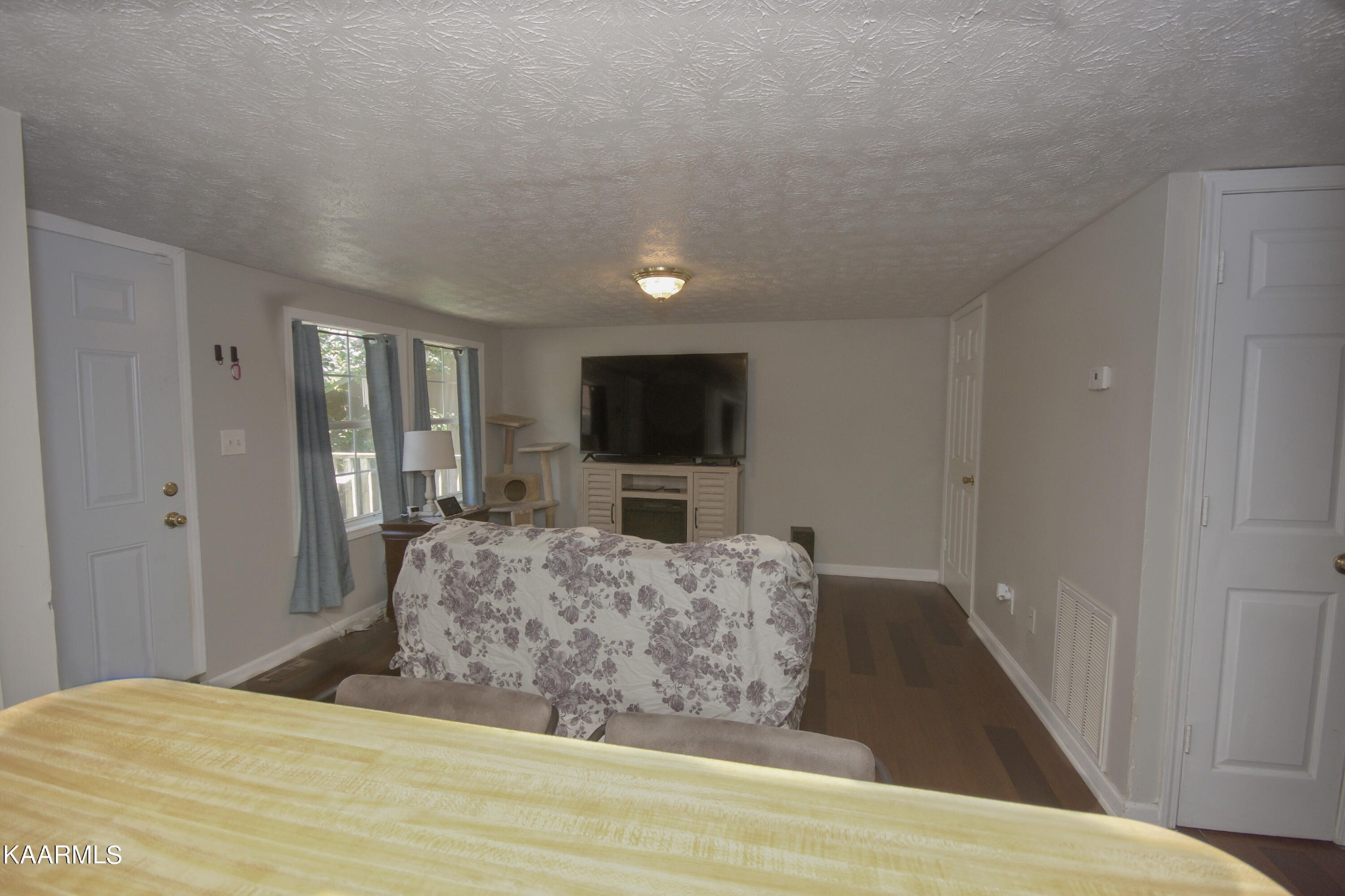 145 Johnson Road Oak Ridge, TN 37830 - Photo 15 of 26 a living room with a bed and a flat screen tv