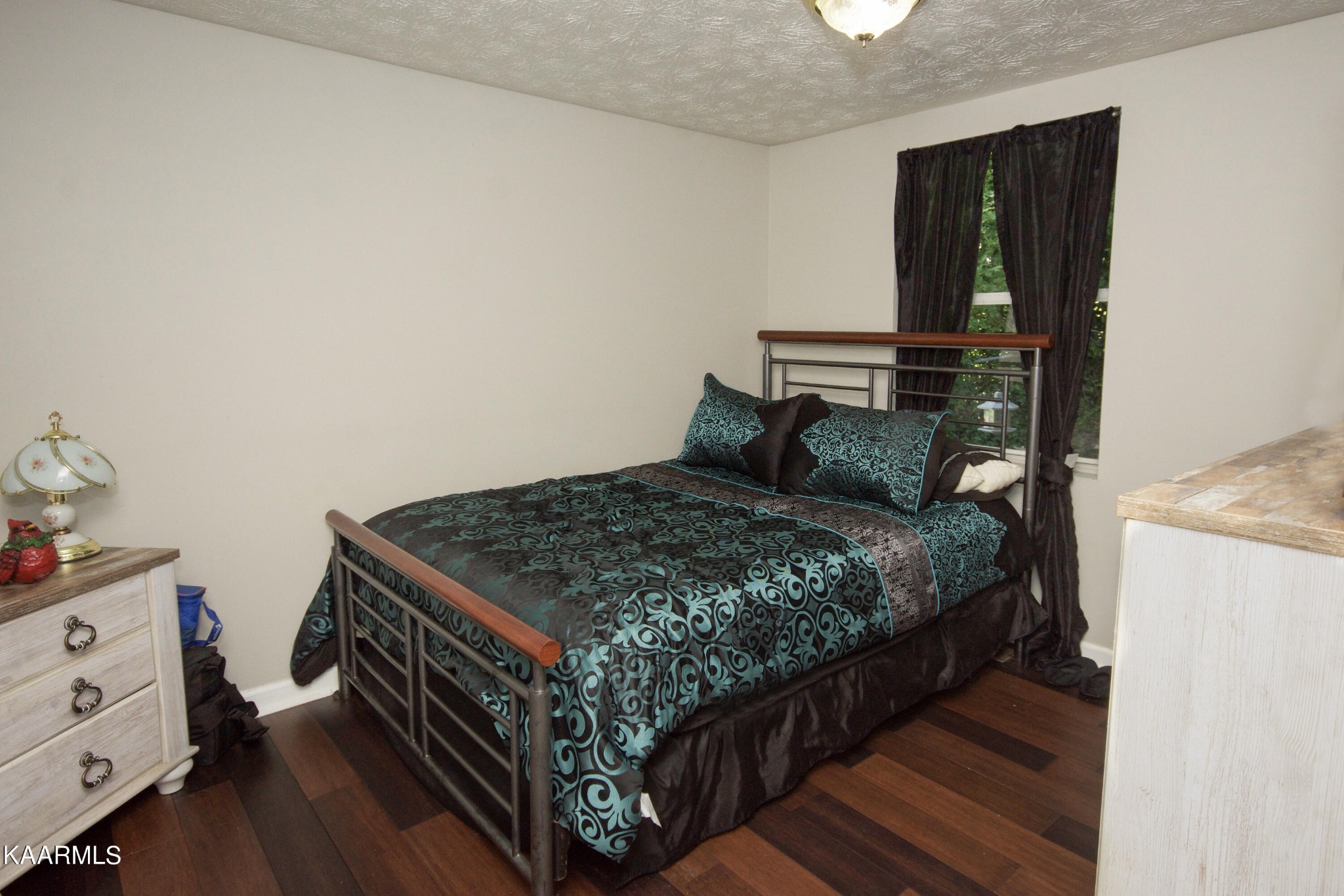 145 Johnson Road Oak Ridge, TN 37830 - Photo 16 of 26 a bedroom with a bed window and a dresser