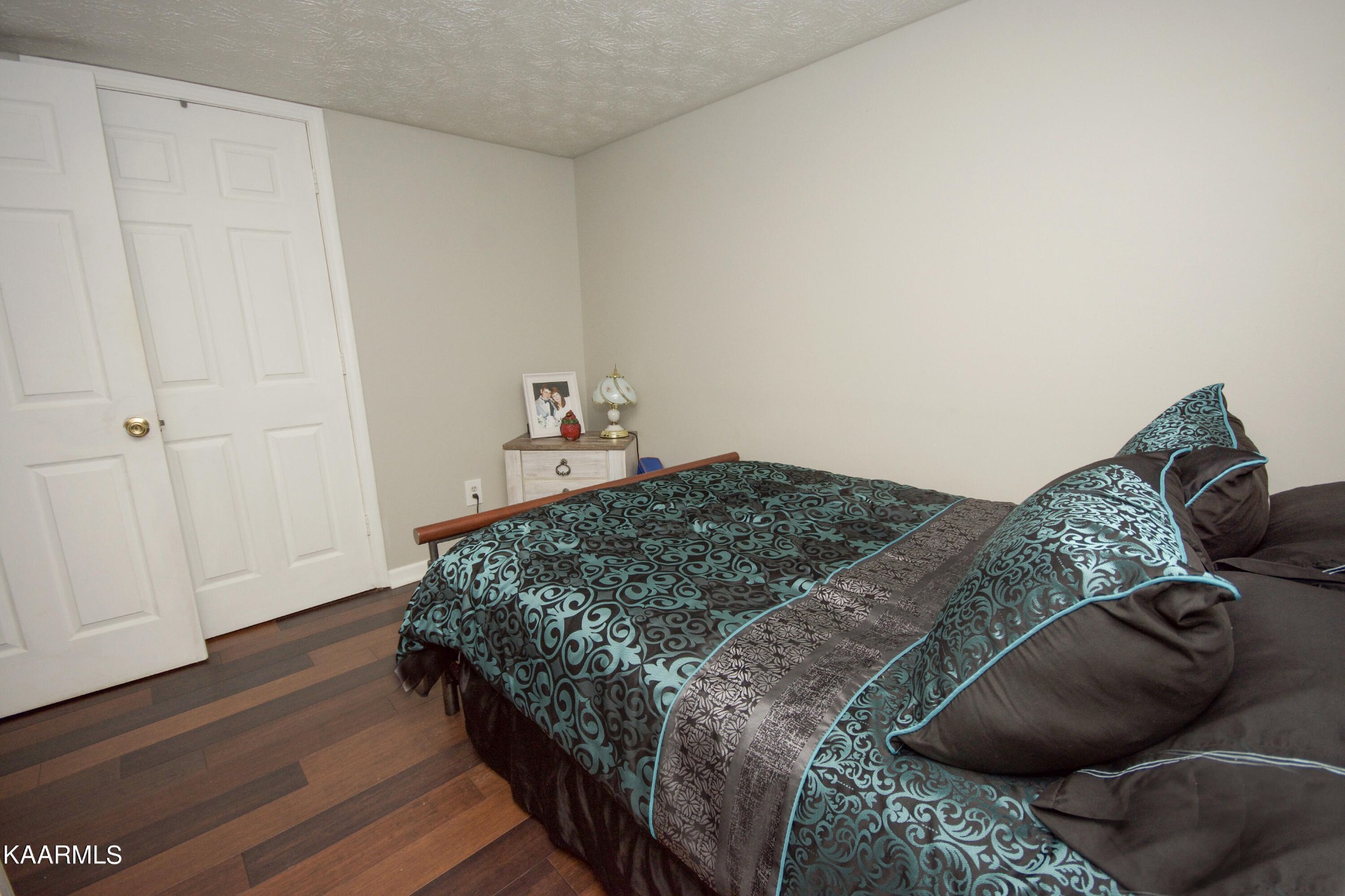 145 Johnson Road Oak Ridge, TN 37830 - Photo 17 of 26 a bedroom with a bed and wooden floor