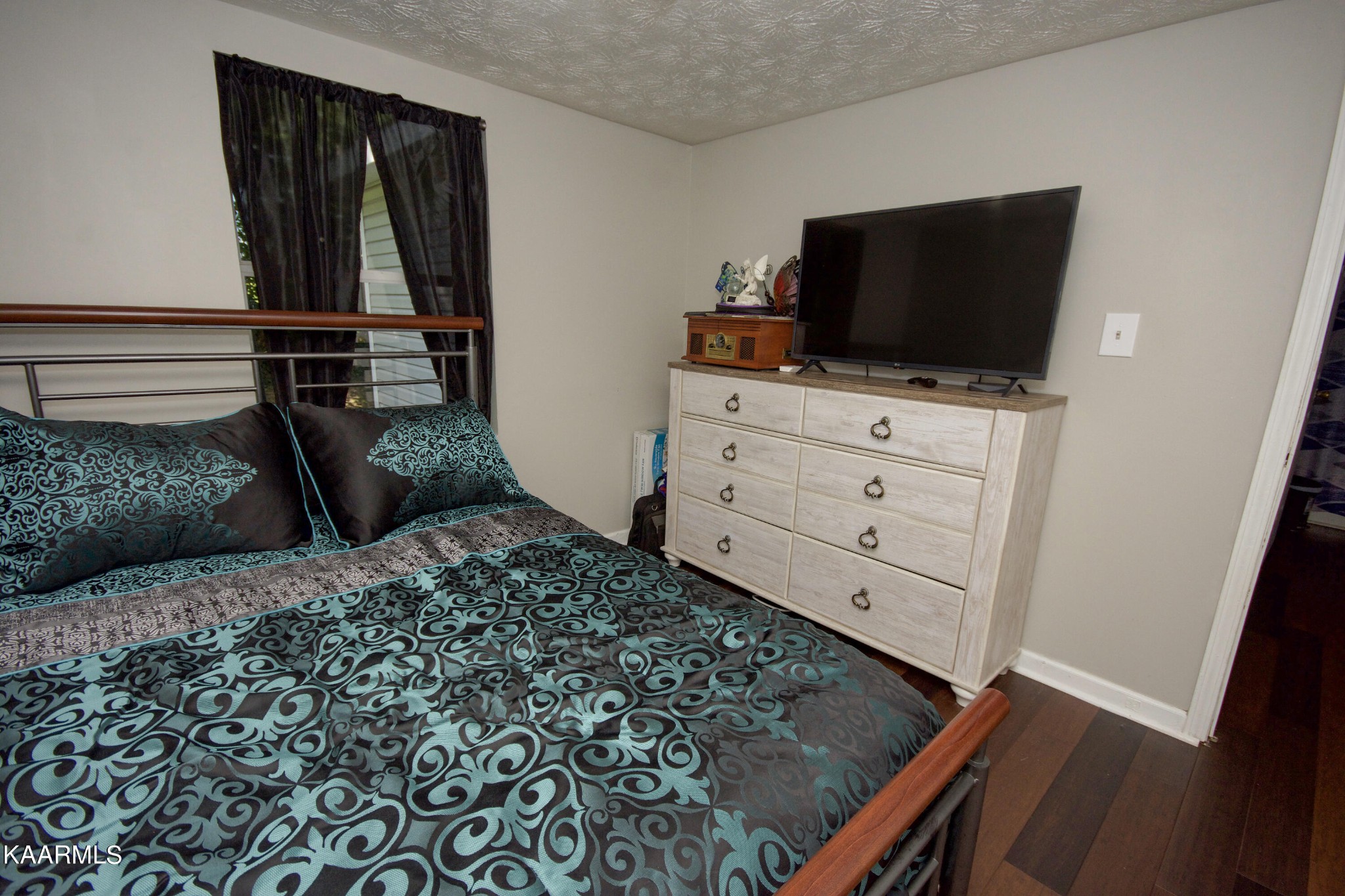 145 Johnson Road Oak Ridge, TN 37830 - Photo 18 of 26 a bedroom with a bed and flat screen tv