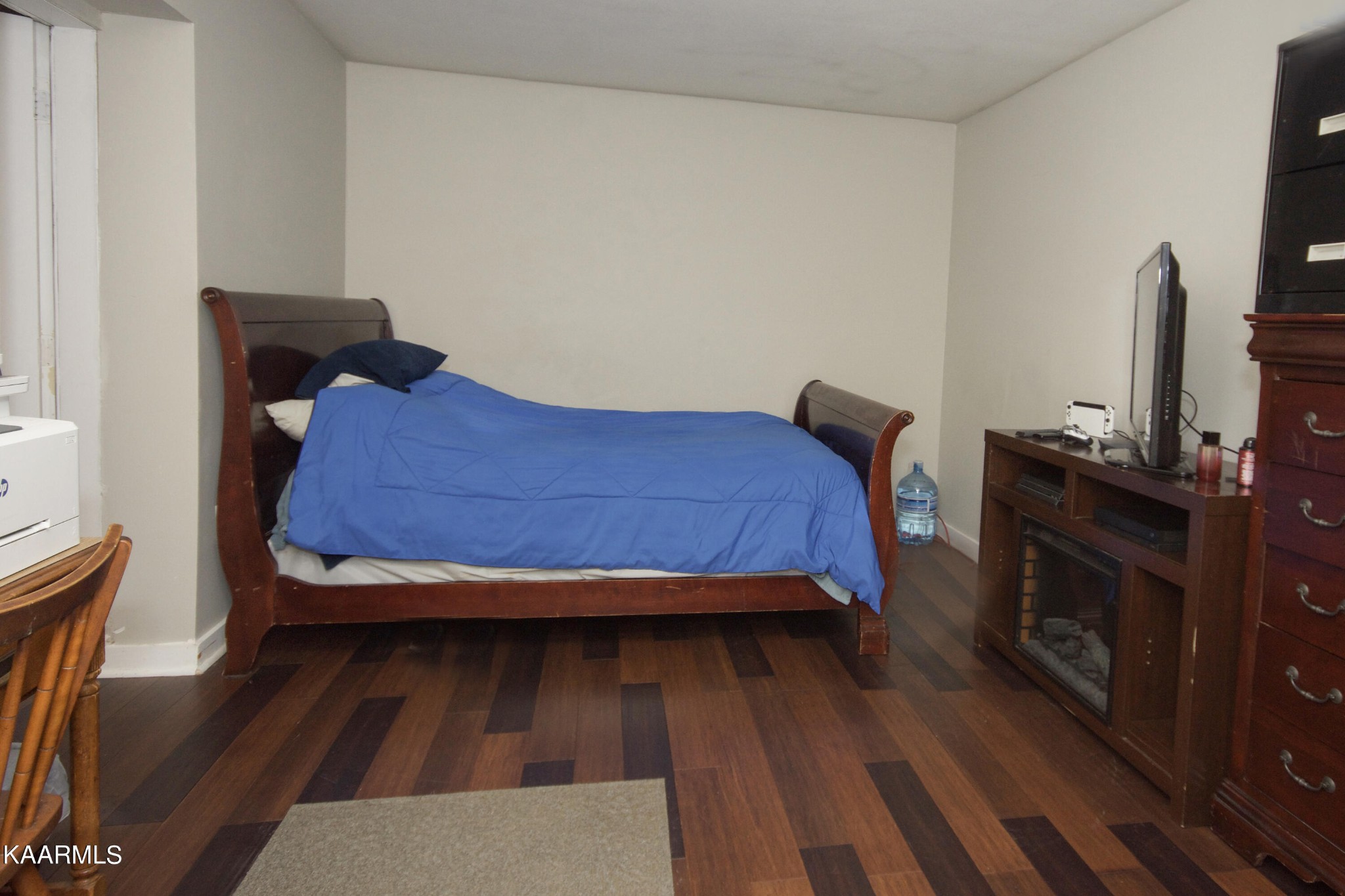 145 Johnson Road Oak Ridge, TN 37830 - Photo 23 of 26 a bedroom with a bed and wooden floor