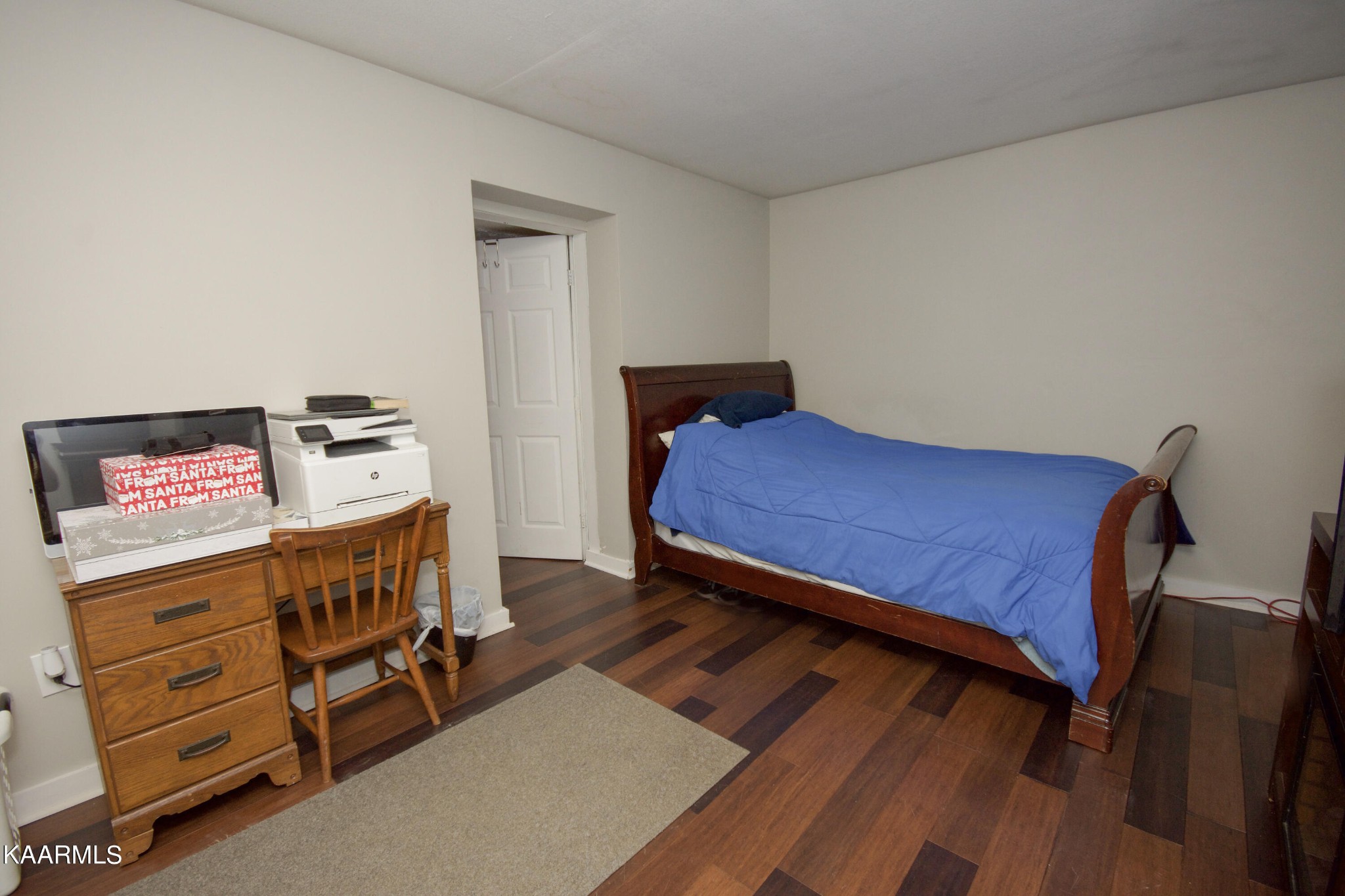 145 Johnson Road Oak Ridge, TN 37830 - Photo 25 of 26 a bedroom with a bed and wooden floor