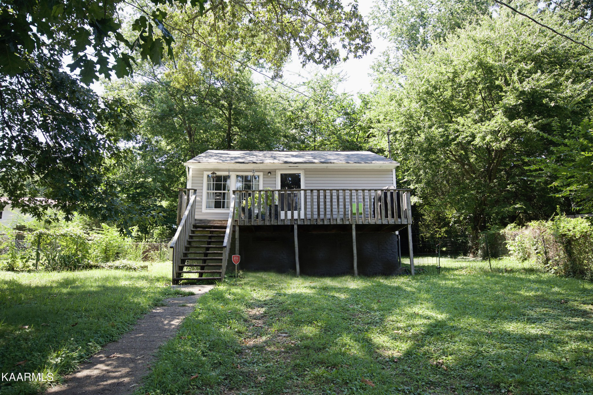 145 Johnson Road Oak Ridge, TN 37830 - Photo 4 of 26 a front view of a house with a garden and trees