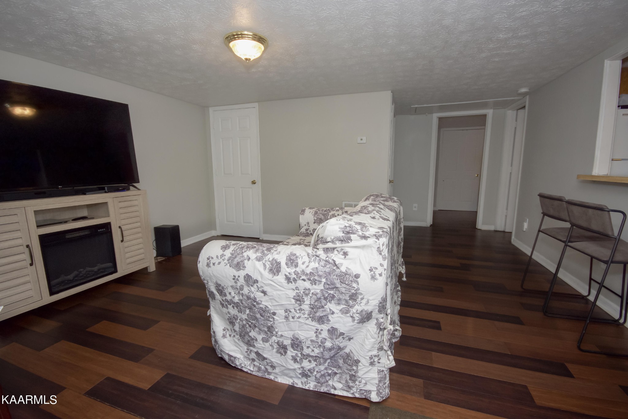 145 Johnson Road Oak Ridge, TN 37830 - Photo 7 of 26 a living room with furniture a flat screen tv and a fireplace