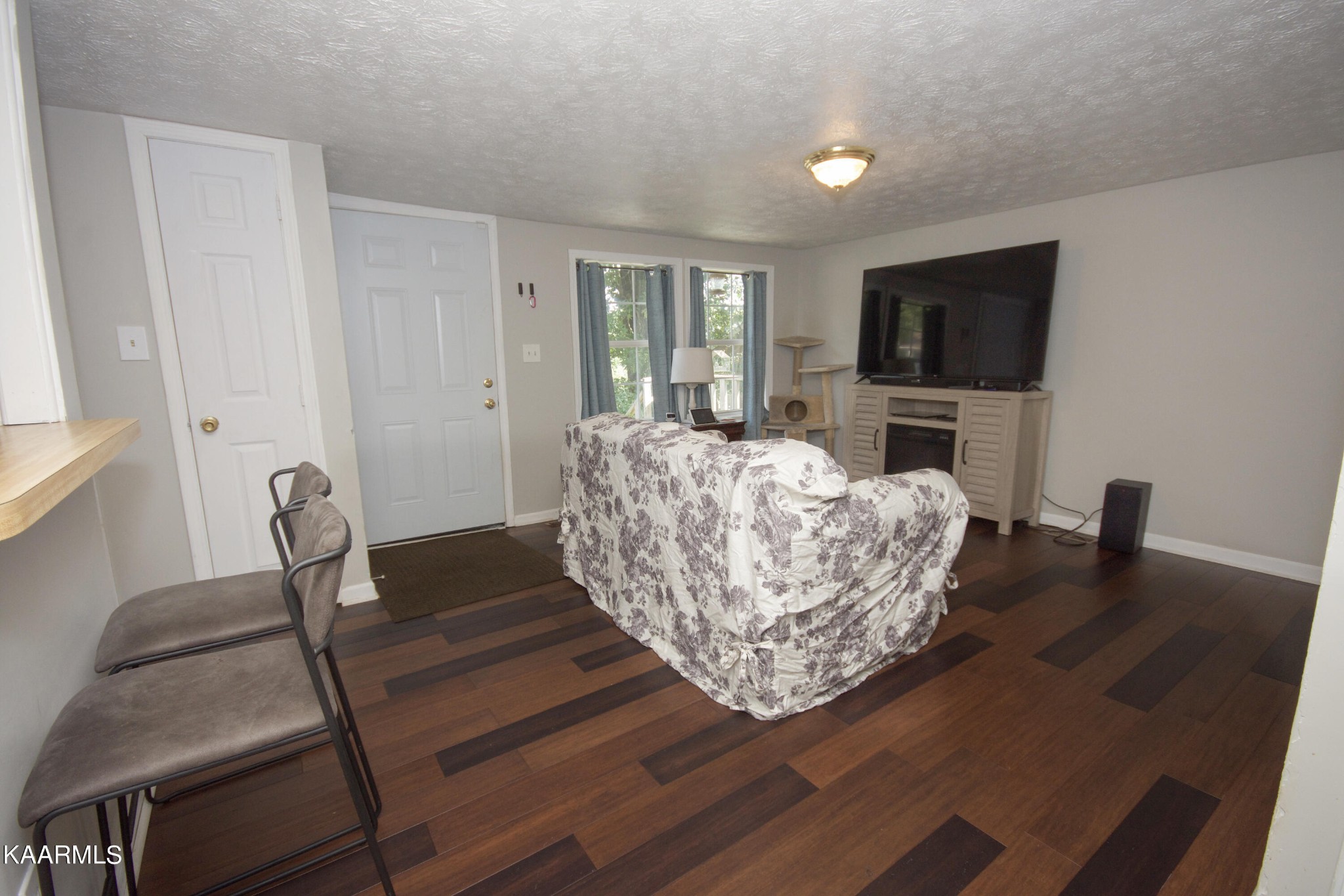 145 Johnson Road Oak Ridge, TN 37830 - Photo 10 of 26 a living room with furniture and a flat screen tv