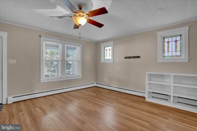 a kitchen with stainless steel appliances a refrigerator a sink and wooden cabinets