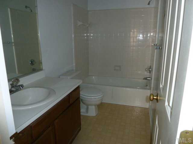5608 Spring Pines Way Raleigh, NC 27616 - Photo 11 of 15 a bathroom with a granite countertop sink a toilet and shower