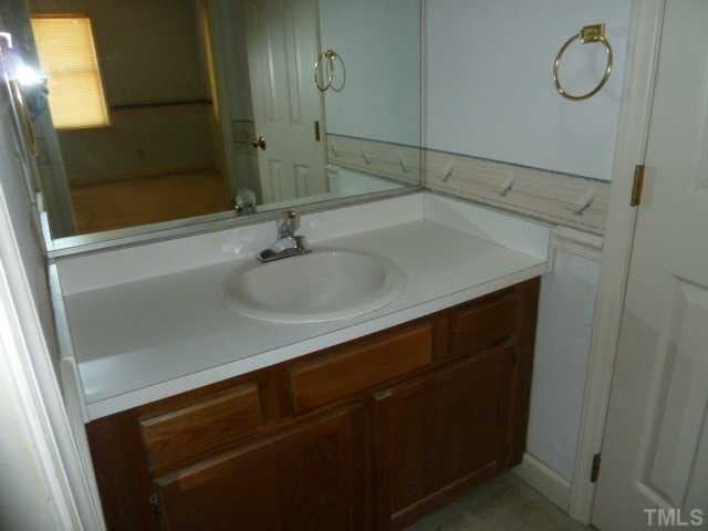 5608 Spring Pines Way Raleigh, NC 27616 - Photo 9 of 15 a bathroom with a sink and a mirror