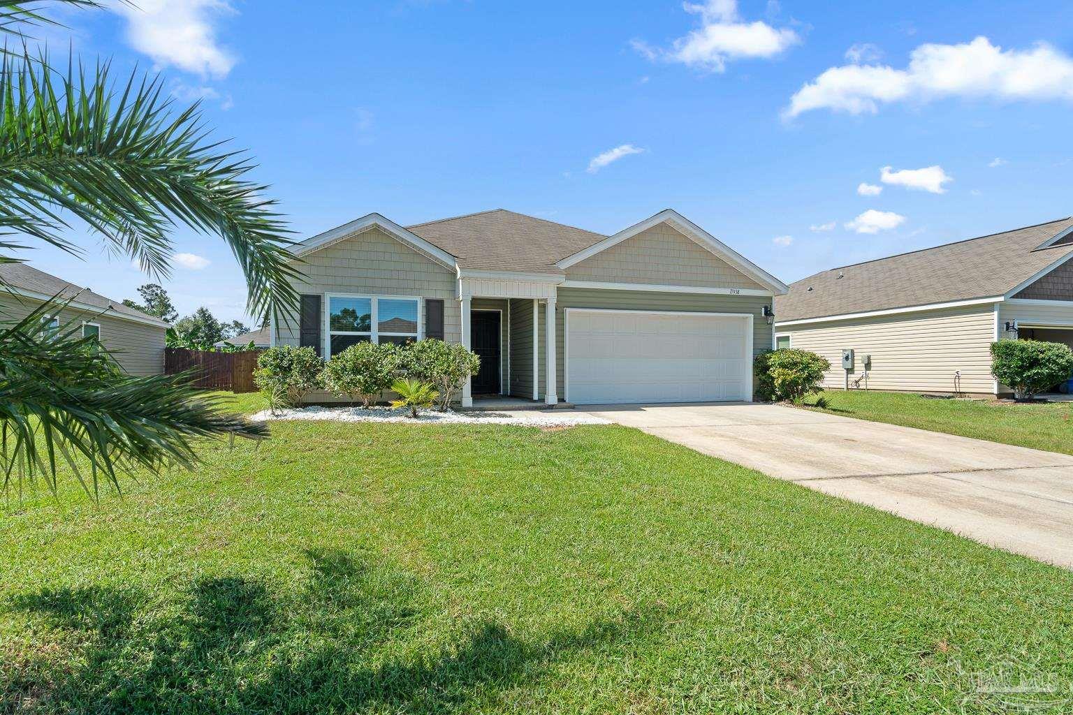 17438 Harding Drive Foley, AL 36535 - Photo 1 of 56 a front view of a house with a garden and yard