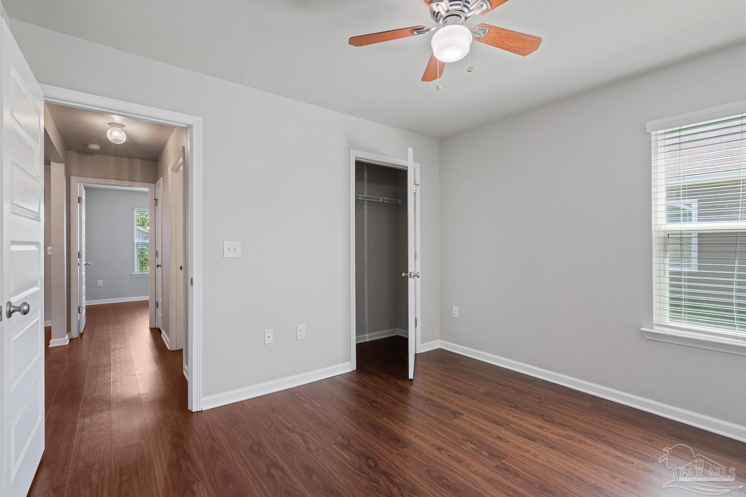 17438 Harding Drive Foley, AL 36535 - Photo 11 of 56 an empty room with wooden floor and windows