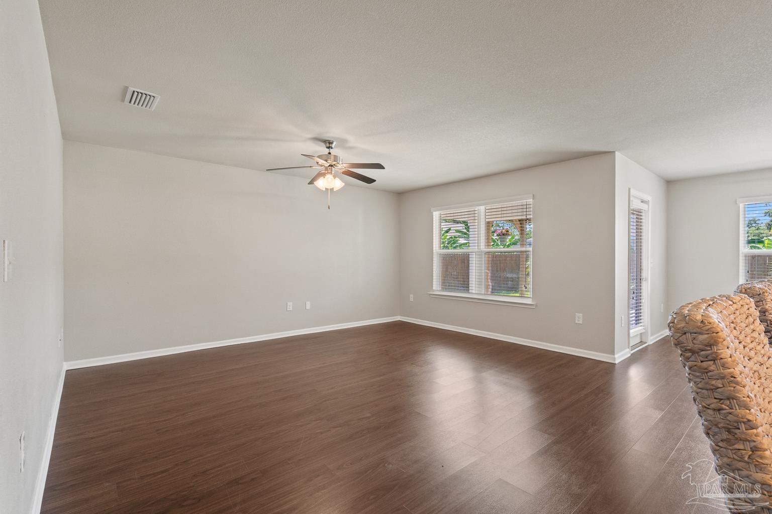 17438 Harding Drive Foley, AL 36535 - Photo 13 of 56 a view of an empty room with wooden floor and a window