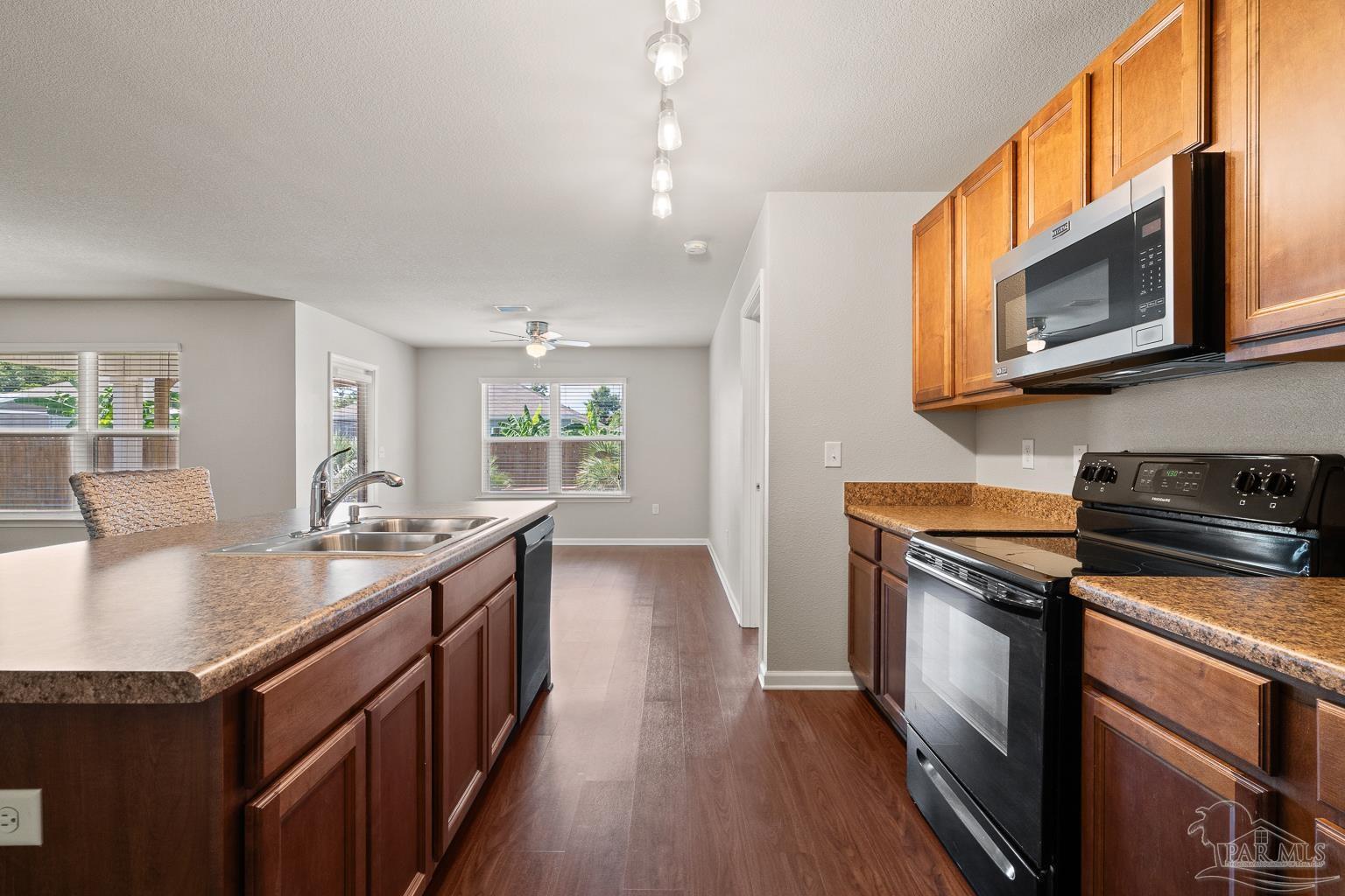 17438 Harding Drive Foley, AL 36535 - Photo 19 of 56 a kitchen with stainless steel appliances granite countertop a stove a sink and a microwave