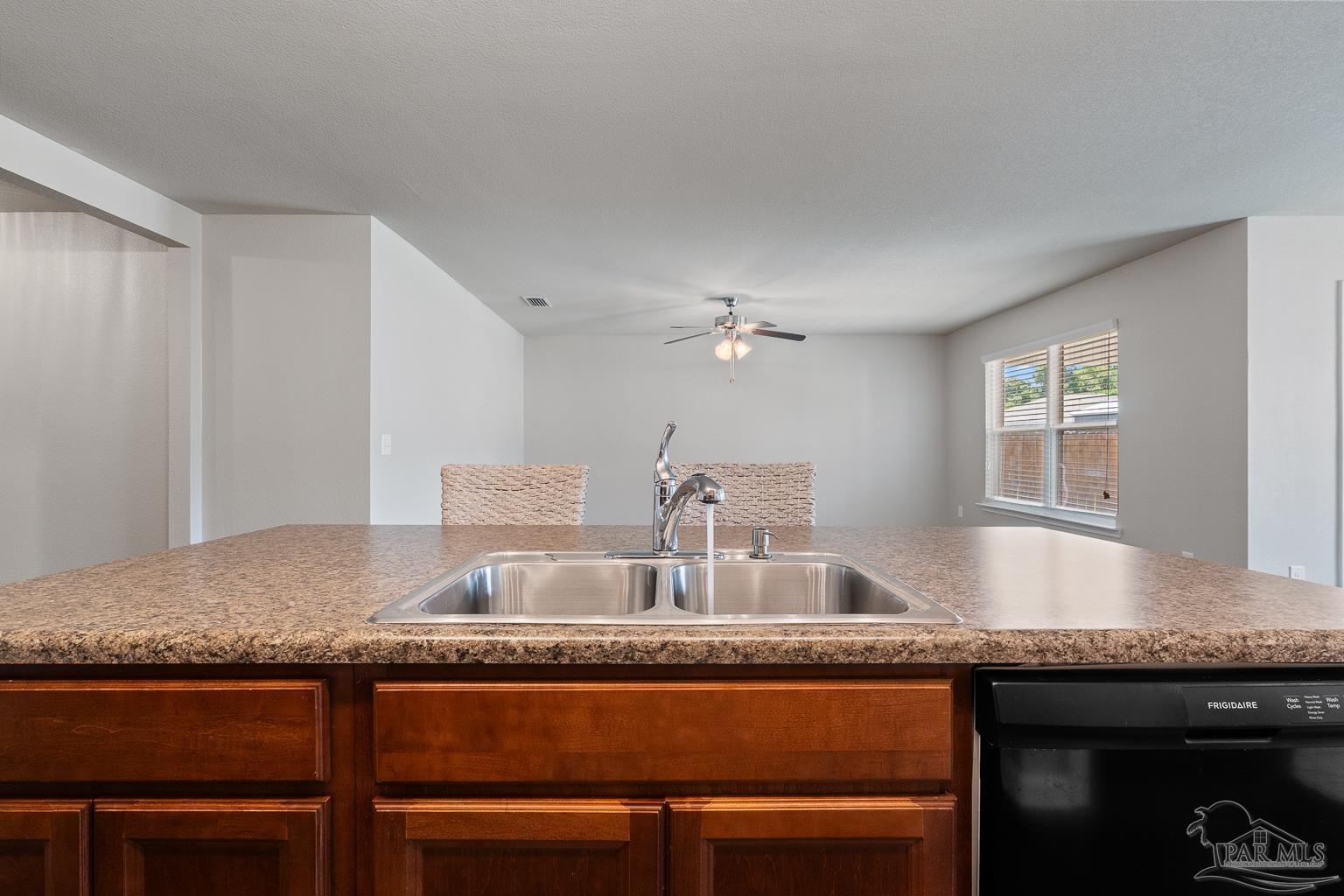 17438 Harding Drive Foley, AL 36535 - Photo 21 of 56 a kitchen with granite countertop a sink chairs and cabinets