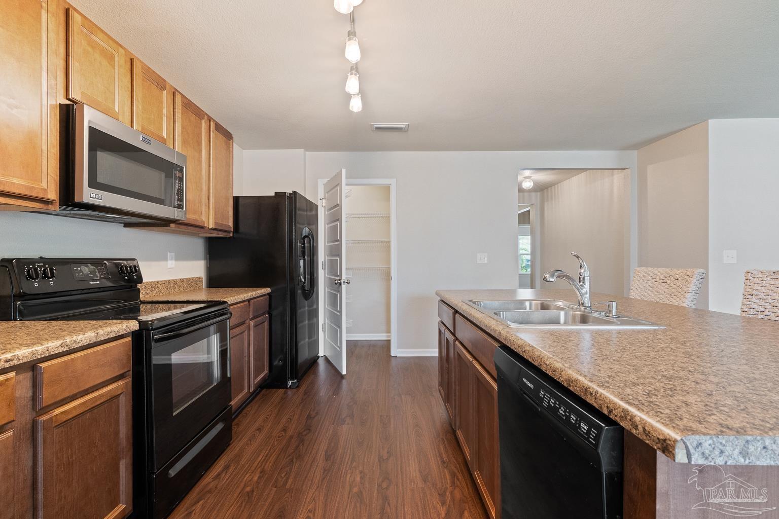 17438 Harding Drive Foley, AL 36535 - Photo 22 of 56 a kitchen with stainless steel appliances granite countertop a sink stove microwave and refrigerator