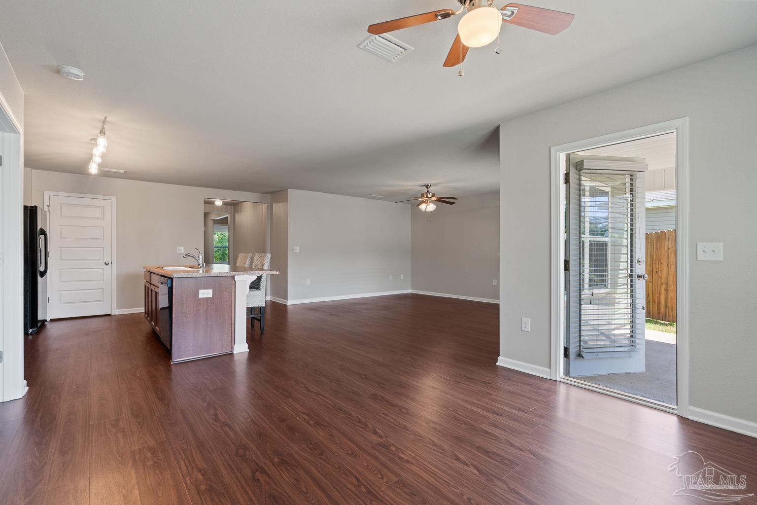 17438 Harding Drive Foley, AL 36535 - Photo 26 of 56 a view of a kitchen with a stove wooden floor and a ceiling fan