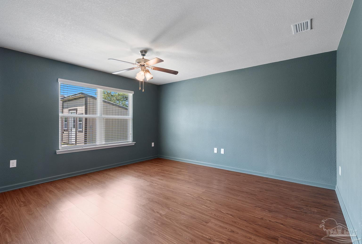 17438 Harding Drive Foley, AL 36535 - Photo 27 of 56 an empty room with wooden floor and windows