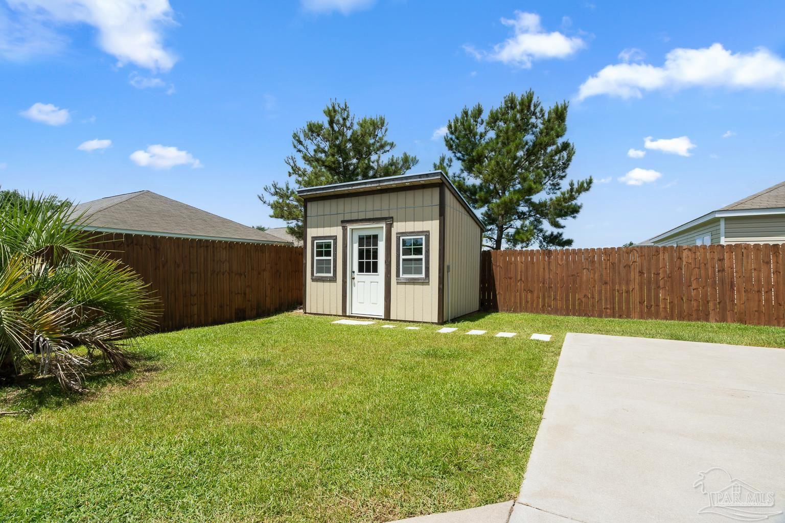 17438 Harding Drive Foley, AL 36535 - Photo 43 of 56 a backyard of a house with plants and a garden