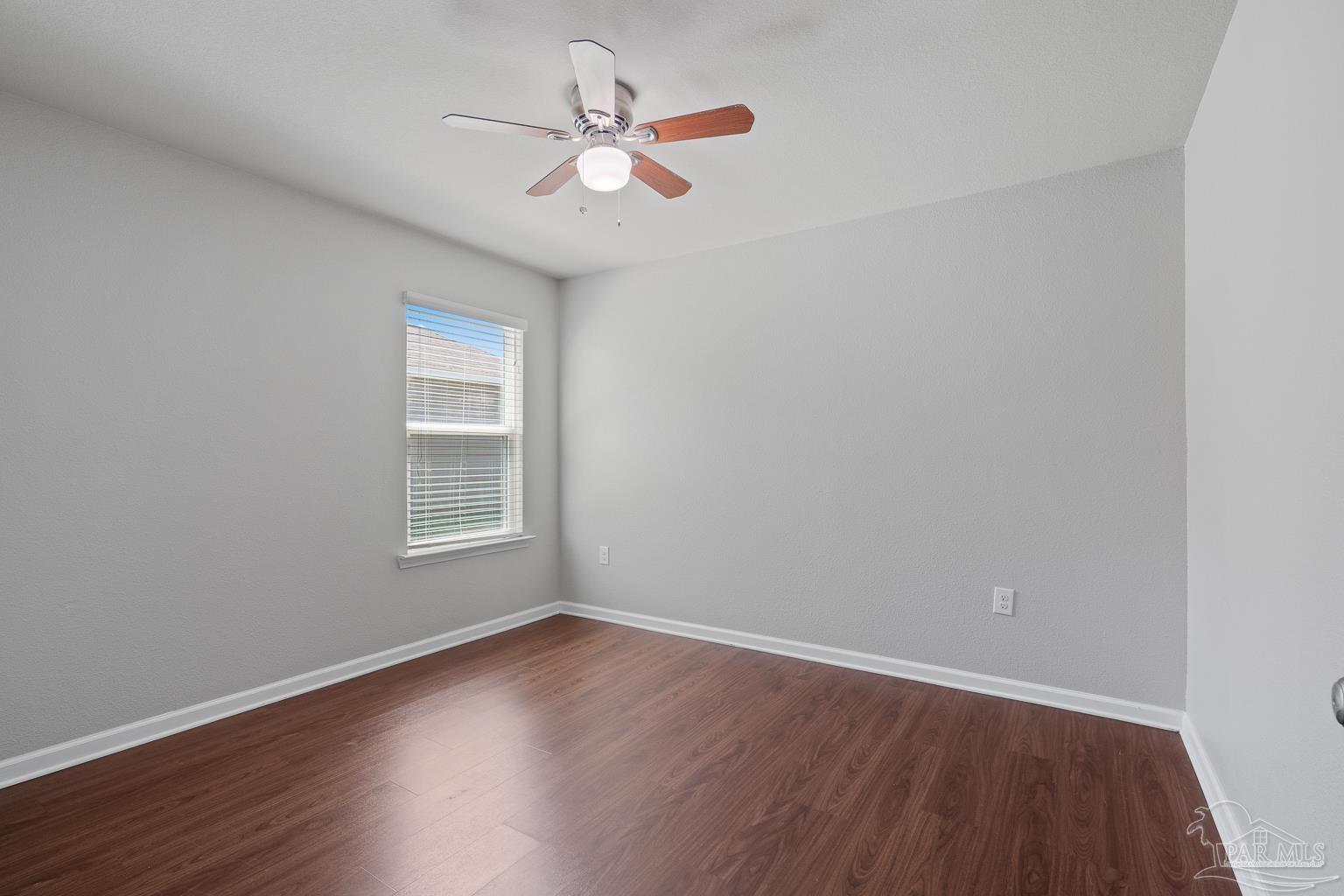 17438 Harding Drive Foley, AL 36535 - Photo 10 of 56 an empty room with wooden floor fan and windows