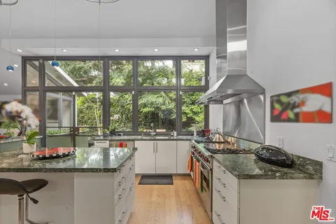 a kitchen with a sink stove and cabinets