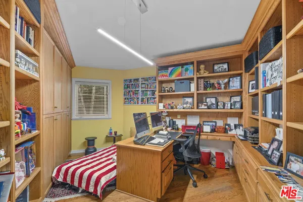 a bed room with a bed and a book shelf