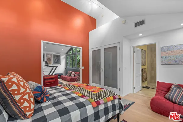 a bedroom with furniture and a window