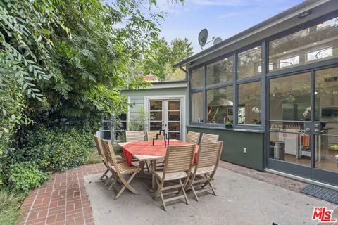 a dining room with furniture and front door