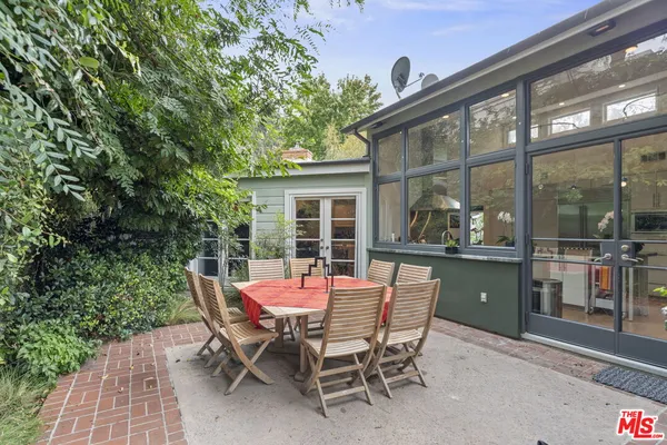 a dining room with furniture and front door