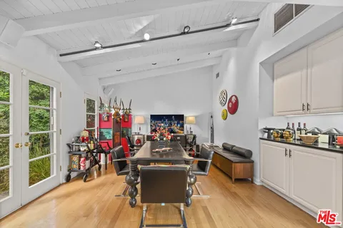 a view of a kitchen with dining table and chairs