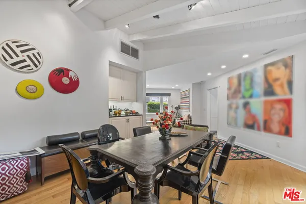 a view of a dining room with furniture and a floor to ceiling window
