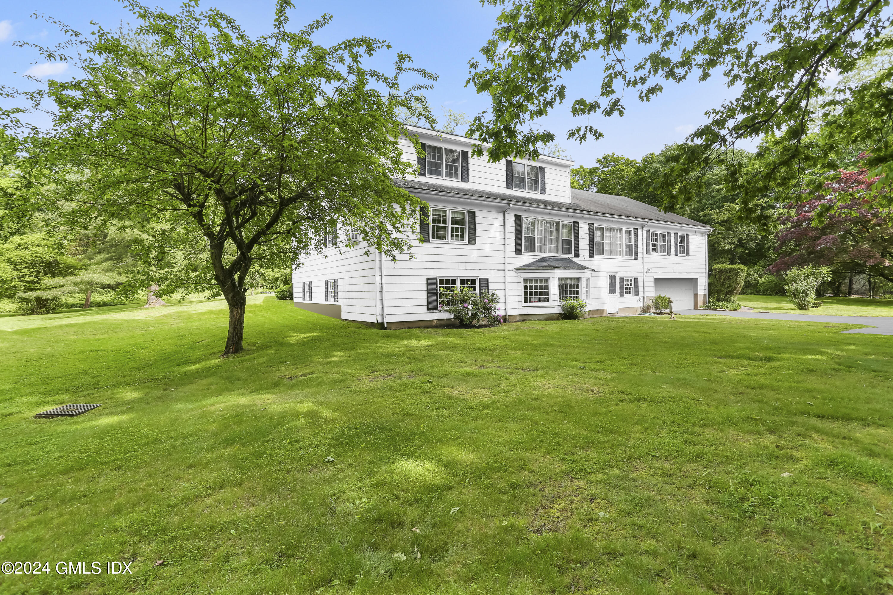 34 Hill Road Greenwich, CT 06830 - Photo 17 of 22 a front view of a house with a yard