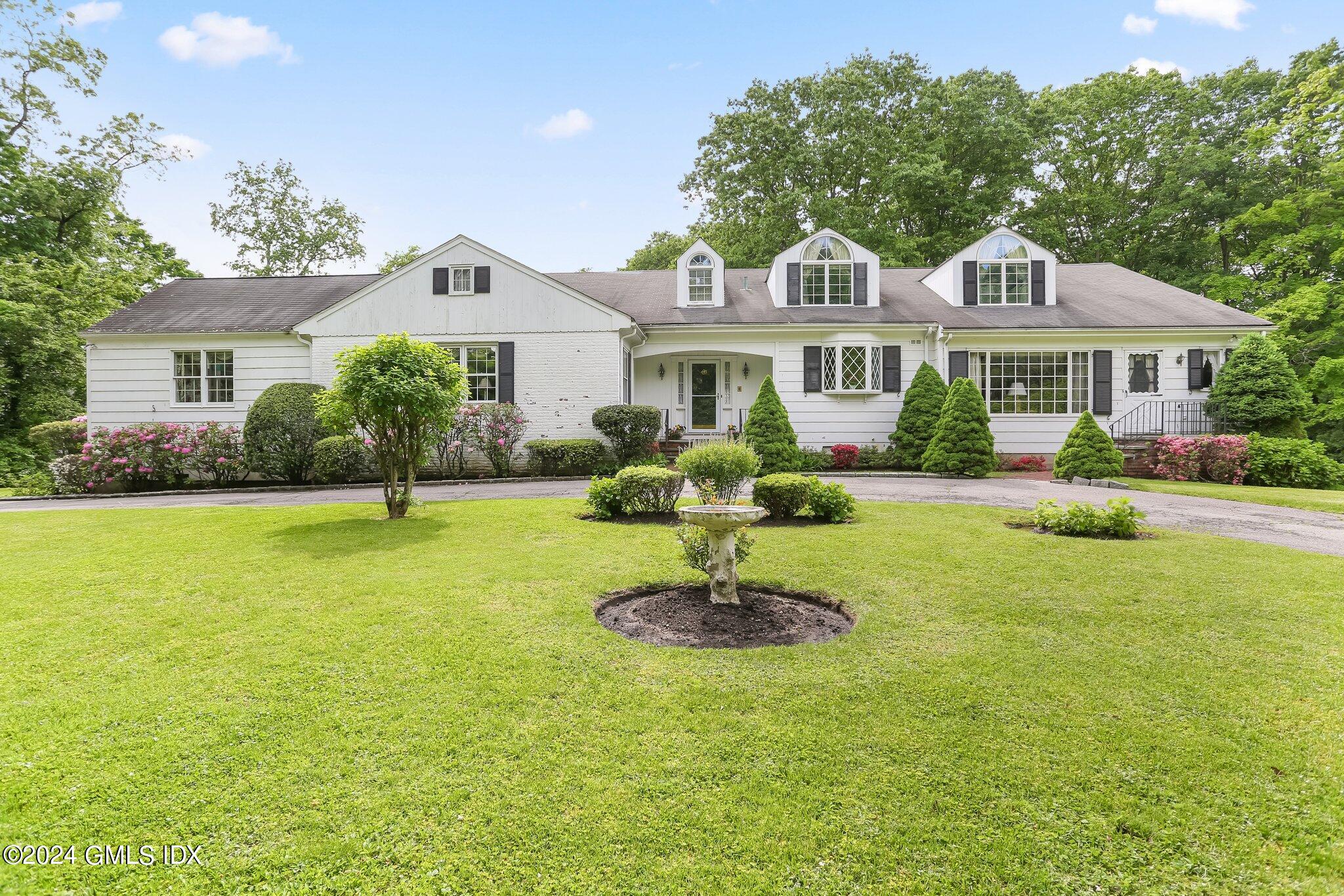 34 Hill Road Greenwich, CT 06830 - Photo 2 of 22 a front view of house with yard and outdoor seating