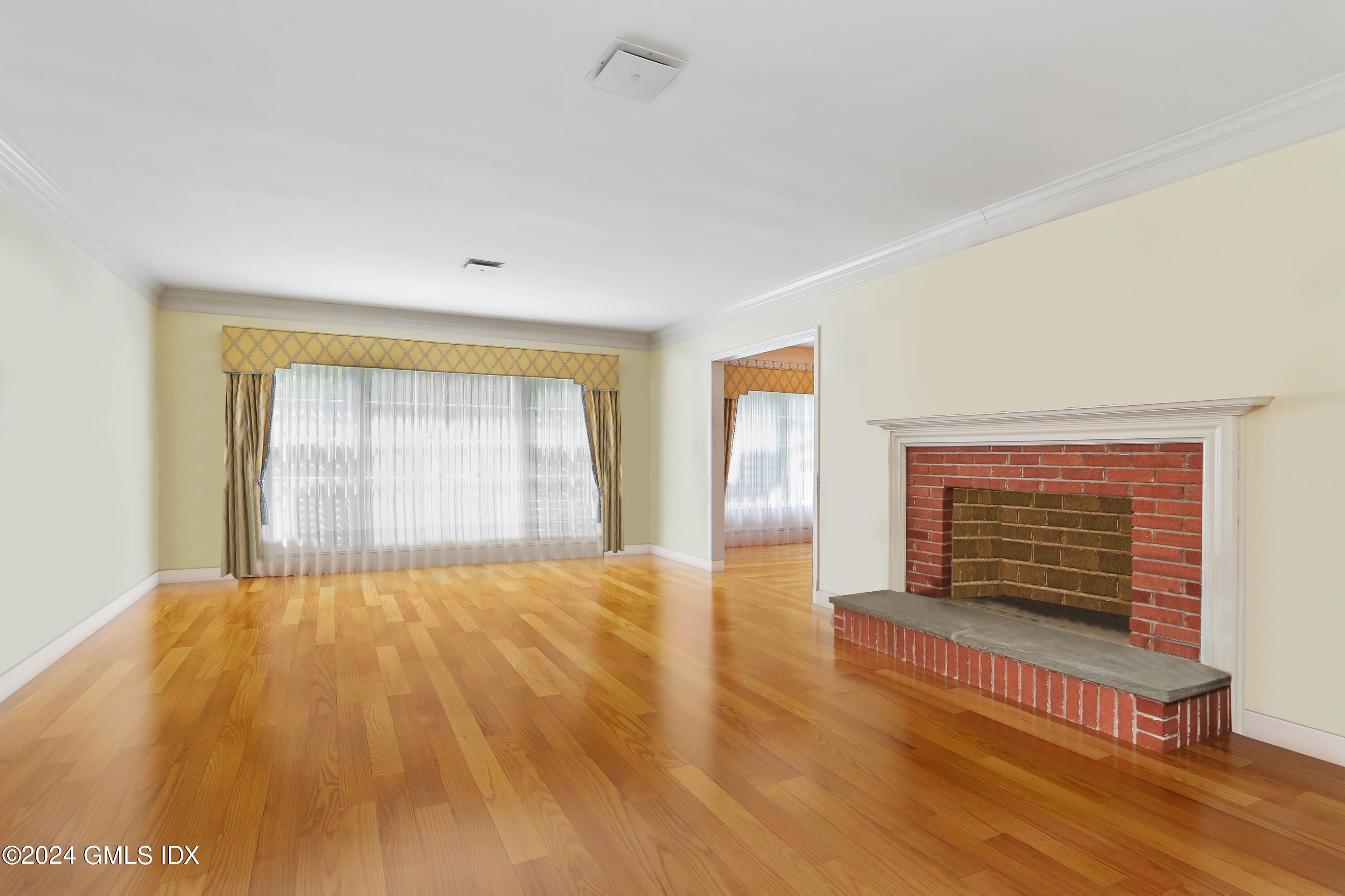 34 Hill Road Greenwich, CT 06830 - Photo 3 of 22 a view of an empty room with wooden floor and a window