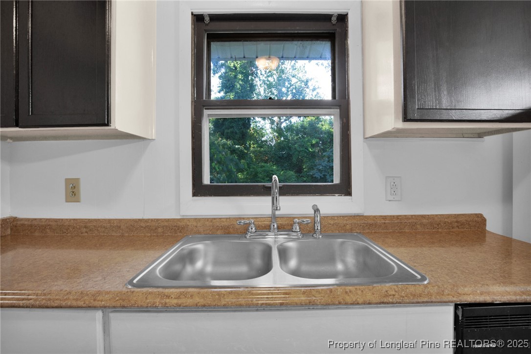 417 Perth Street Fayetteville, NC 28314 - Photo 15 of 30 a kitchen sink with a granite countertop window
