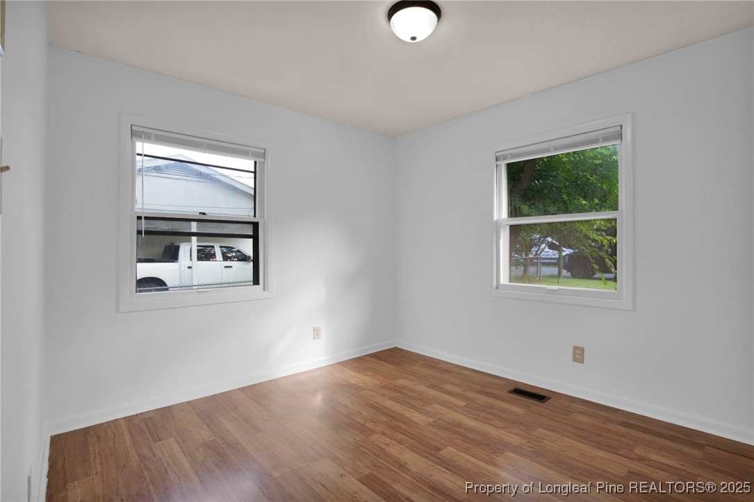417 Perth Street Fayetteville, NC 28314 - Photo 19 of 30 a view of an empty room with wooden floor and a window