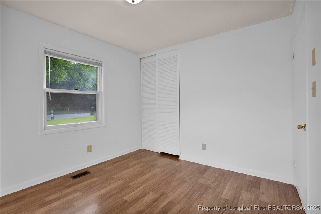 417 Perth Street Fayetteville, NC 28314 - Photo 20 of 30 a view of an empty room with wooden floor and a window