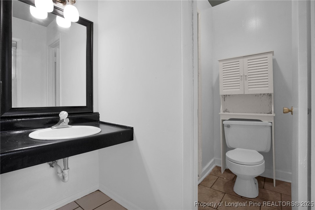 417 Perth Street Fayetteville, NC 28314 - Photo 24 of 30 a bathroom with a toilet sink and mirror