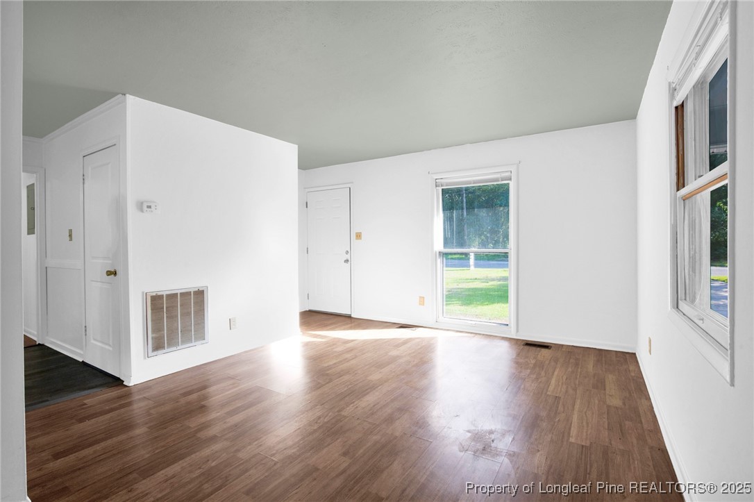 417 Perth Street Fayetteville, NC 28314 - Photo 6 of 30 a view of an empty room with wooden floor and a window