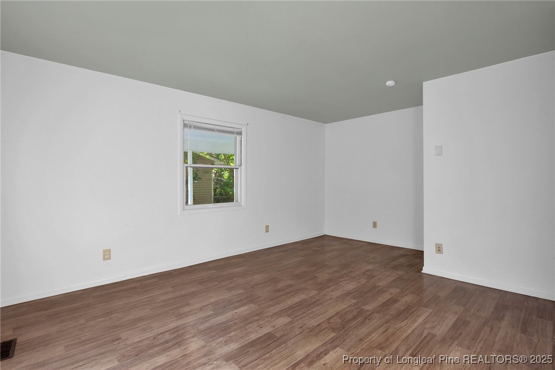 417 Perth Street Fayetteville, NC 28314 - Photo 8 of 30 a view of an empty room with wooden floor and a window