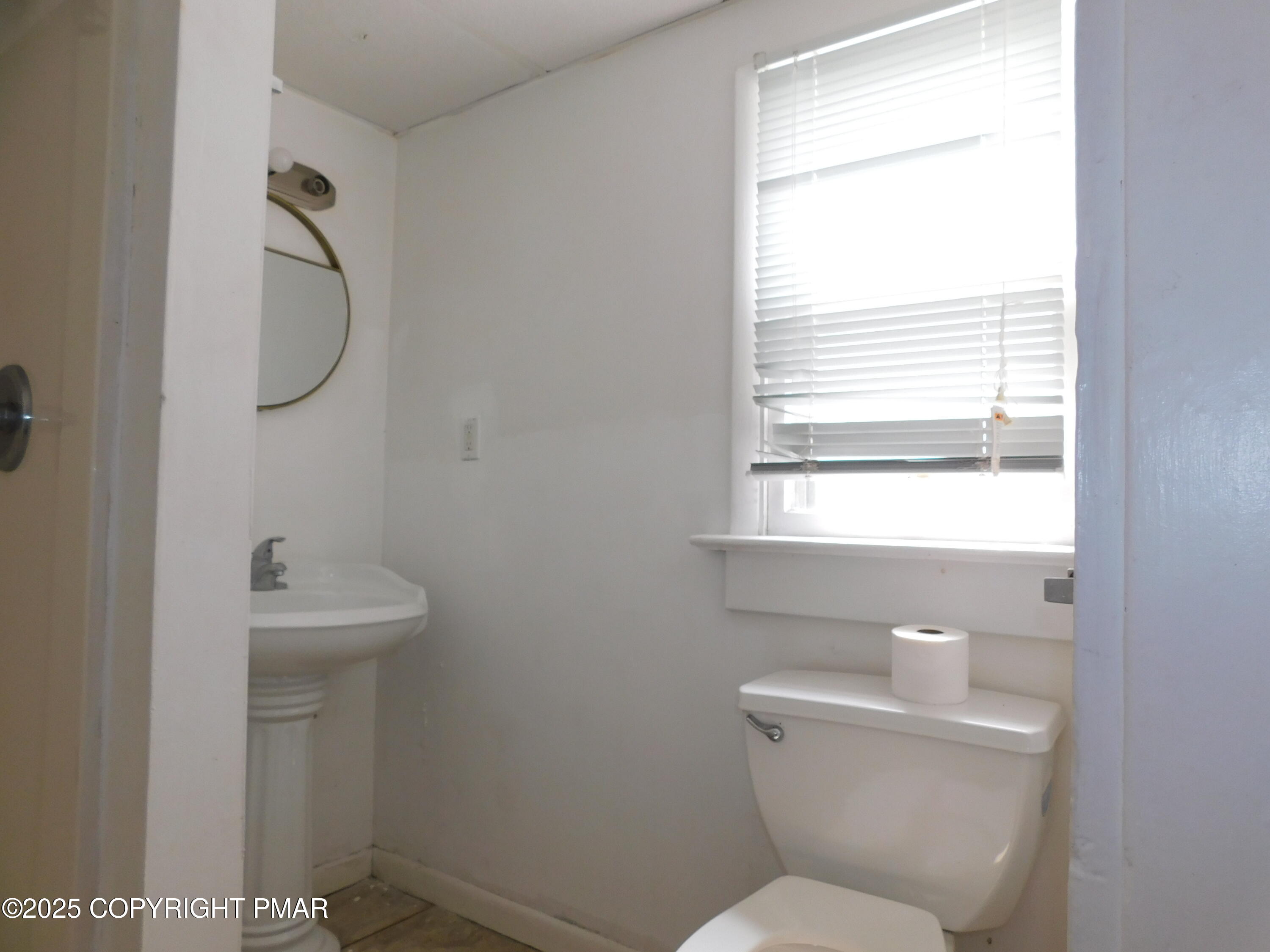 112 Ridgeway Street East Stroudsburg, PA 18301 - Photo 12 of 39 a bathroom with a toilet sink and mirror