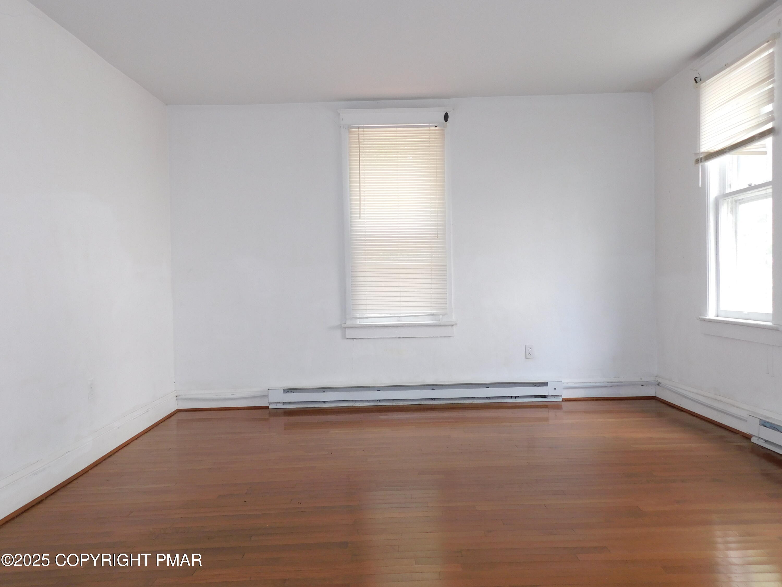 112 Ridgeway Street East Stroudsburg, PA 18301 - Photo 20 of 39 an empty room with wooden floor and windows
