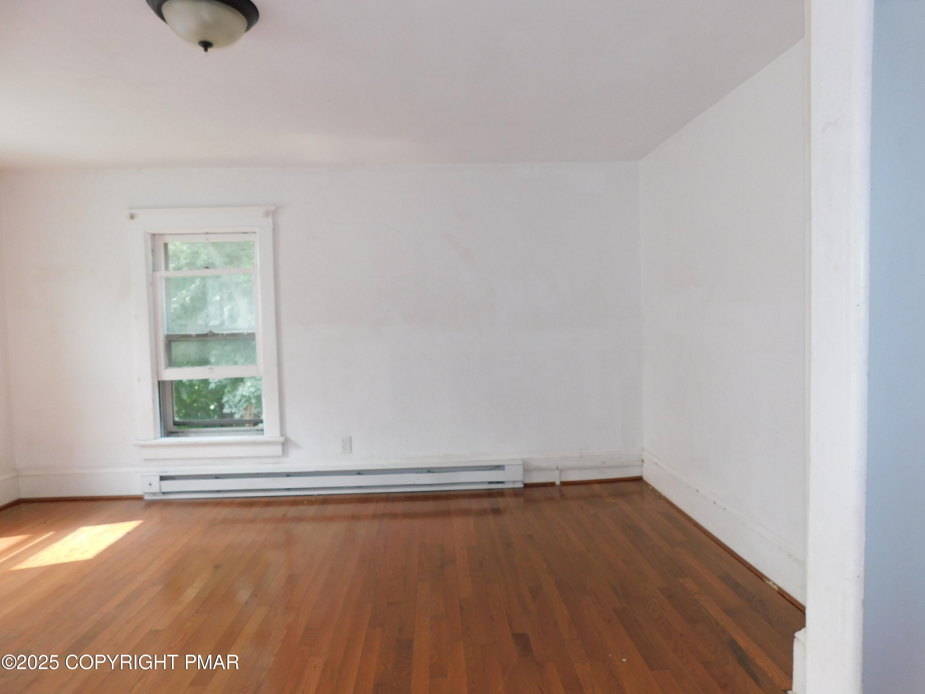 112 Ridgeway Street East Stroudsburg, PA 18301 - Photo 25 of 39 an empty room with wooden floor and windows