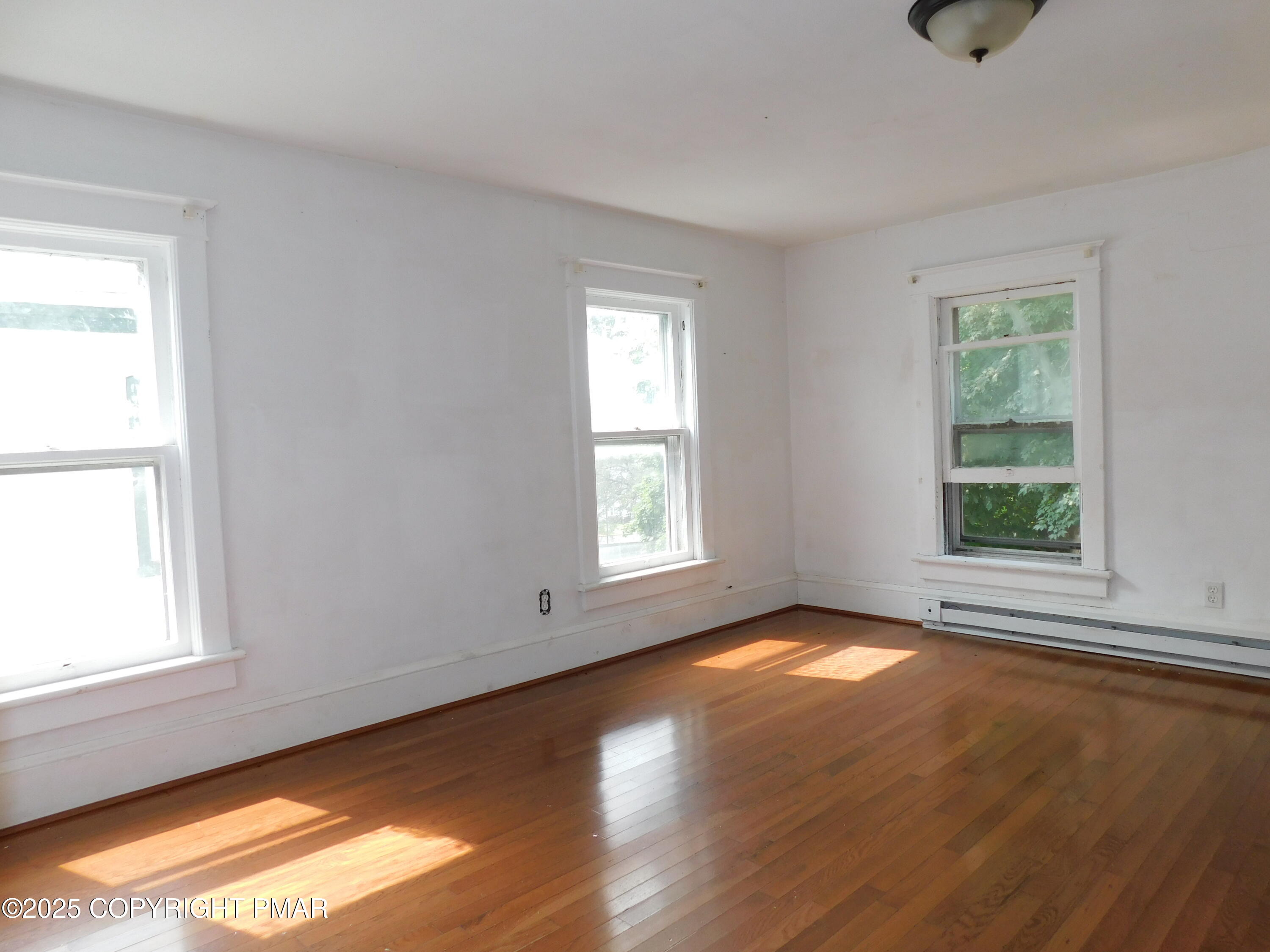 112 Ridgeway Street East Stroudsburg, PA 18301 - Photo 26 of 39 a view of an empty room with wooden floor and a window