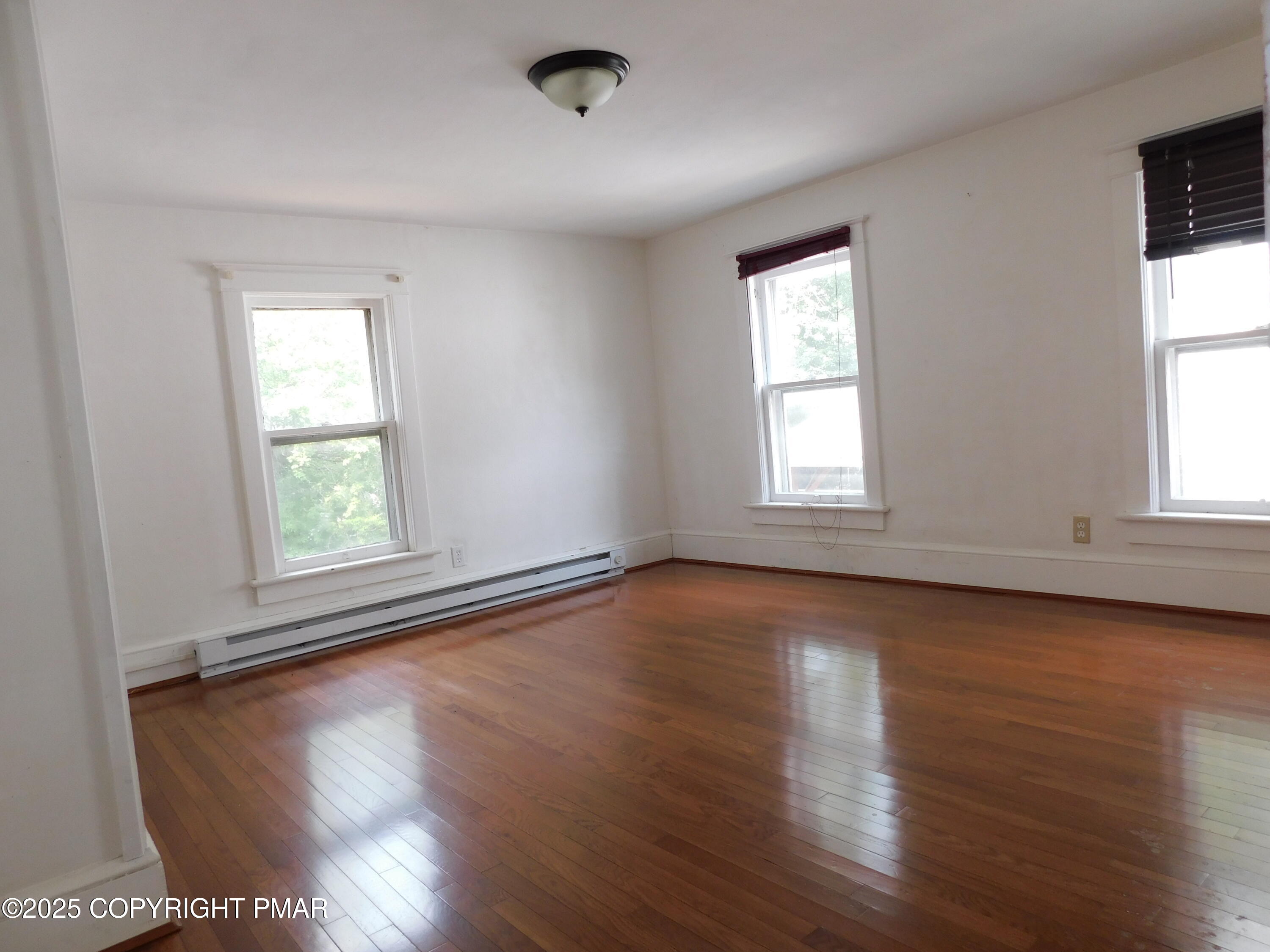 112 Ridgeway Street East Stroudsburg, PA 18301 - Photo 27 of 39 an empty room with wooden floor and windows