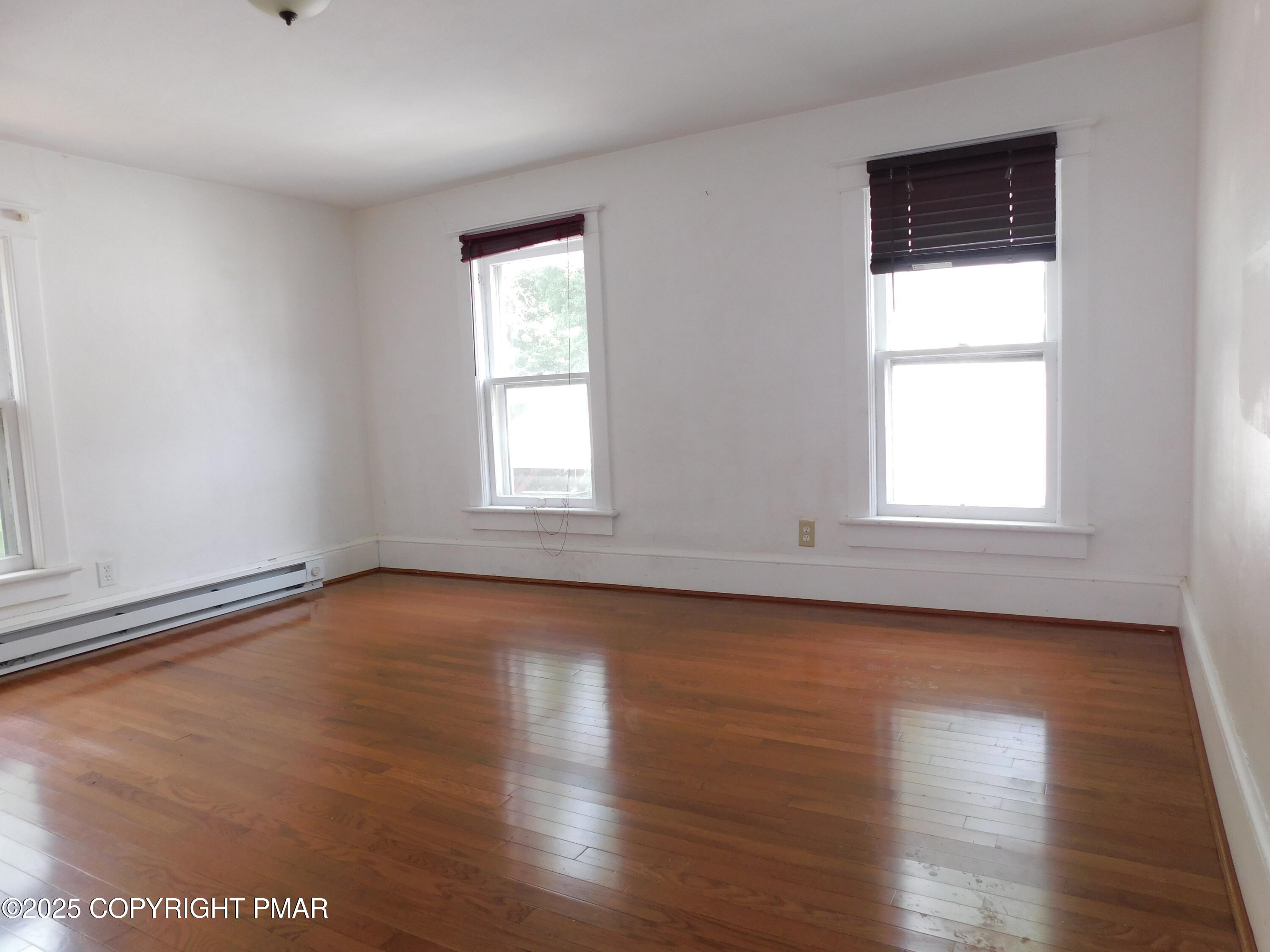 112 Ridgeway Street East Stroudsburg, PA 18301 - Photo 28 of 39 an empty room with wooden floor and windows