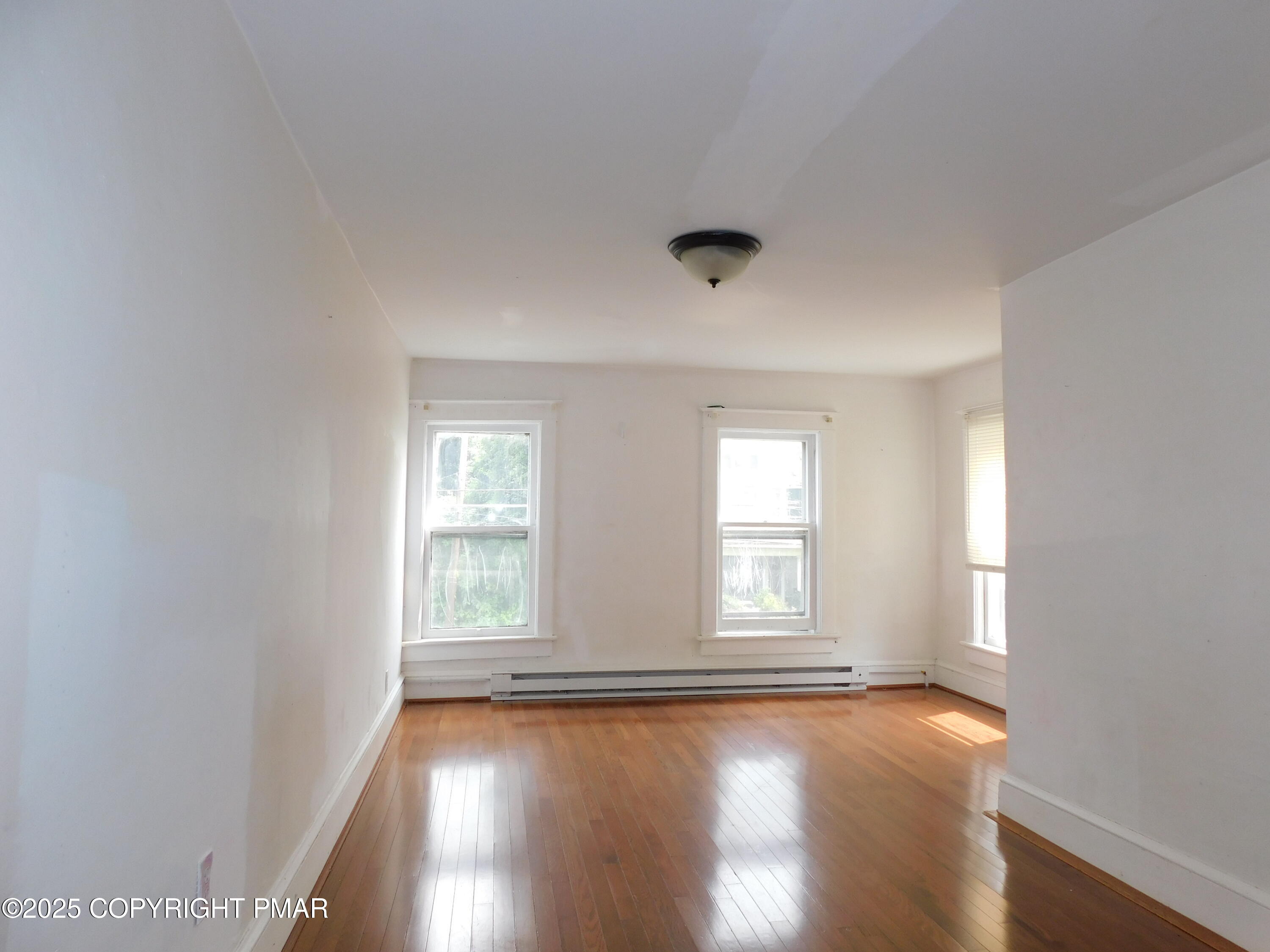 112 Ridgeway Street East Stroudsburg, PA 18301 - Photo 30 of 39 an empty room with wooden floor and windows