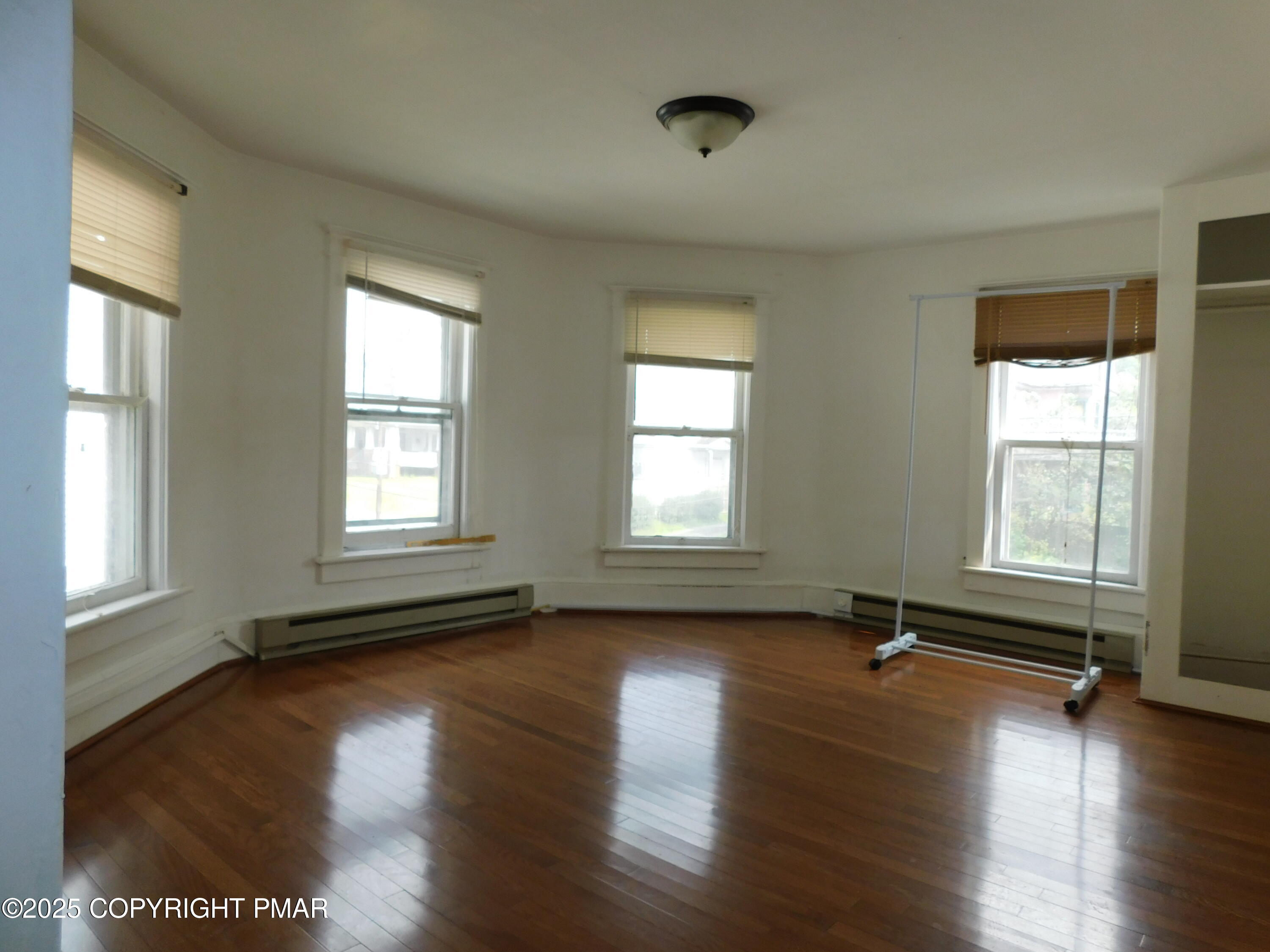 112 Ridgeway Street East Stroudsburg, PA 18301 - Photo 31 of 39 an empty room with wooden floor and windows