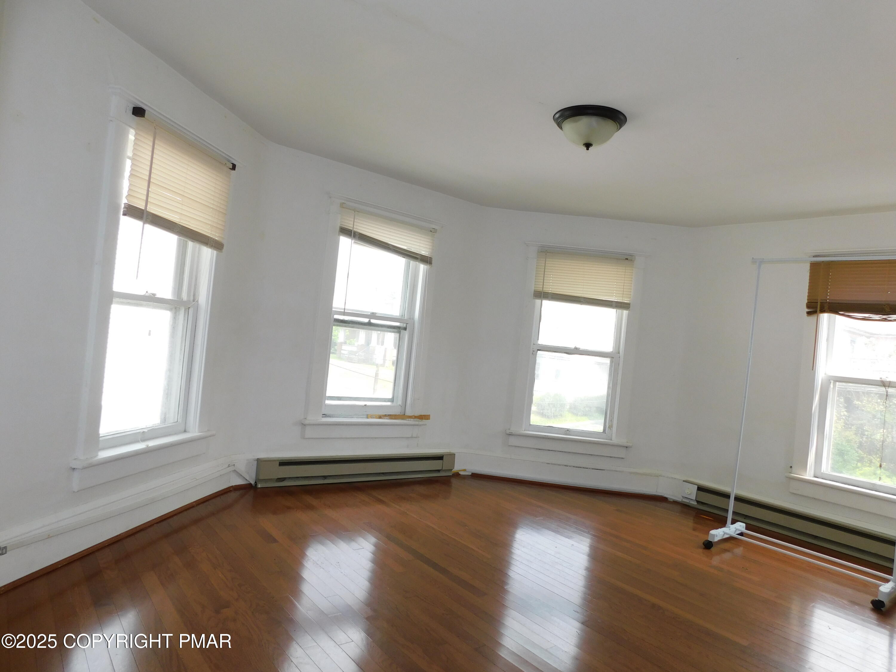 112 Ridgeway Street East Stroudsburg, PA 18301 - Photo 32 of 39 an empty room with wooden floor and windows